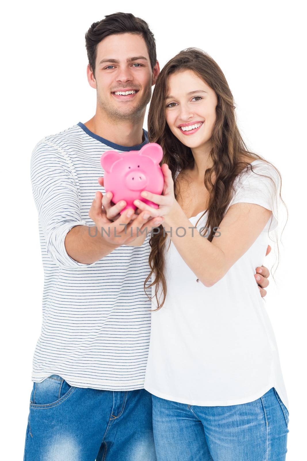 Couple holding piggy bank on white background