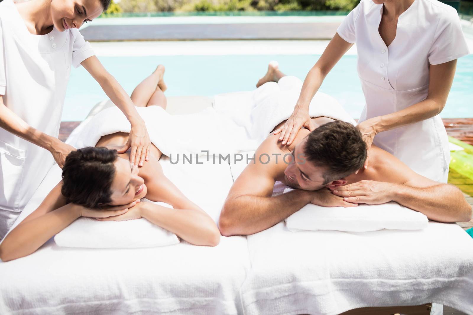 Young couple receiving a back massage from masseur by Wavebreakmedia