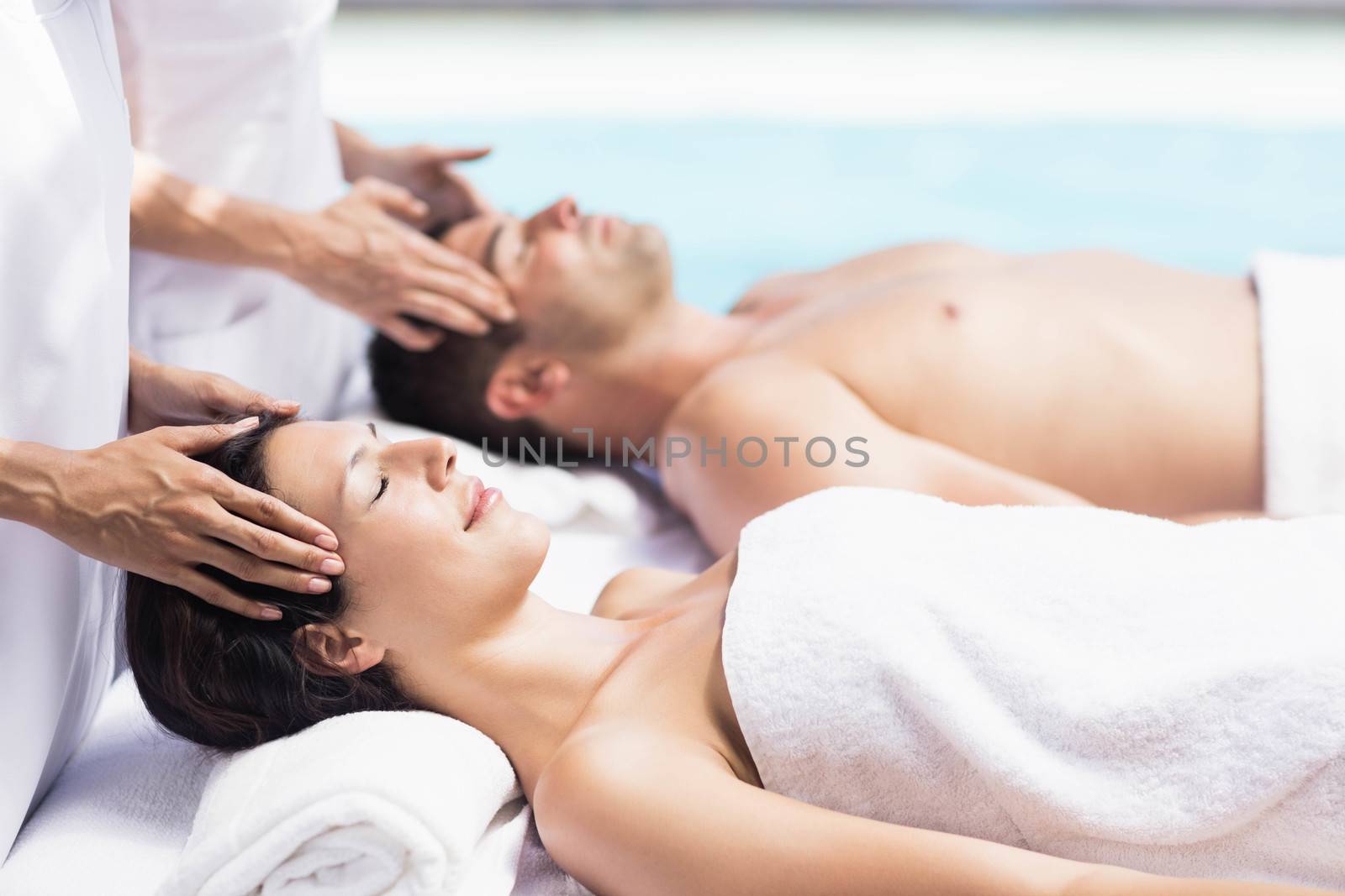 Couple receiving a head massage from masseur by Wavebreakmedia