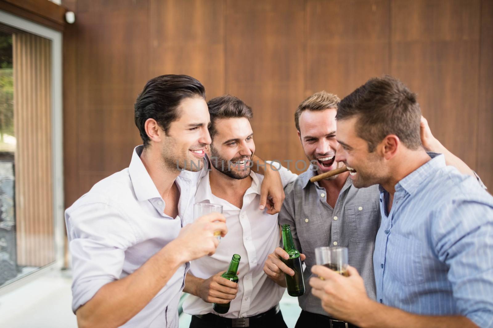 Group of young men having drinks by Wavebreakmedia
