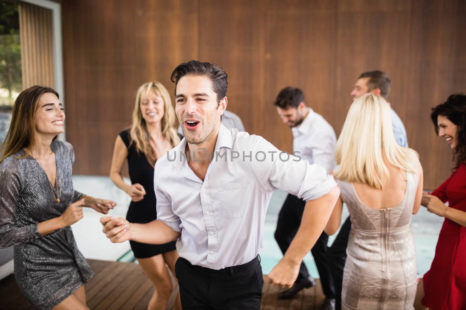 Group of young friends dancing by Wavebreakmedia