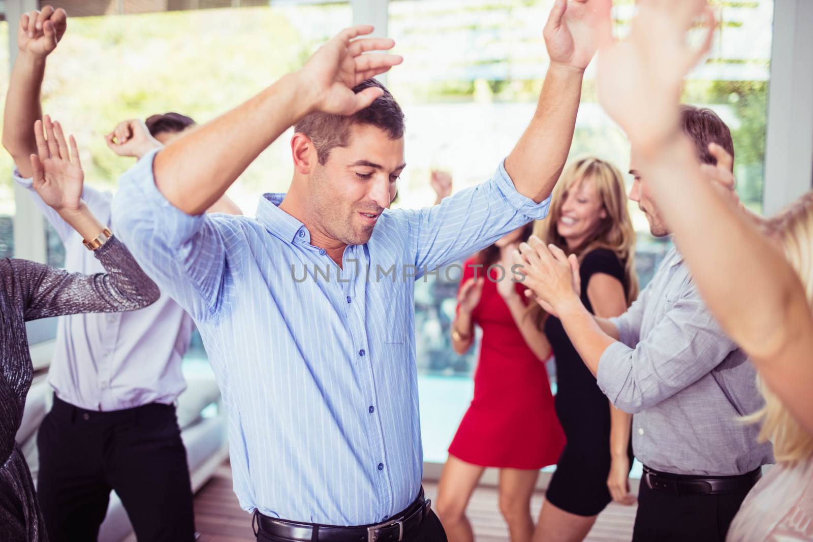 Group of young friends dancing at the party