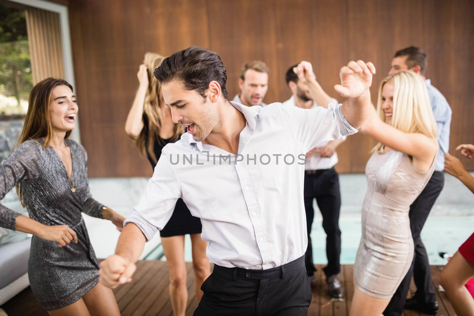 Group of young friends dancing by Wavebreakmedia
