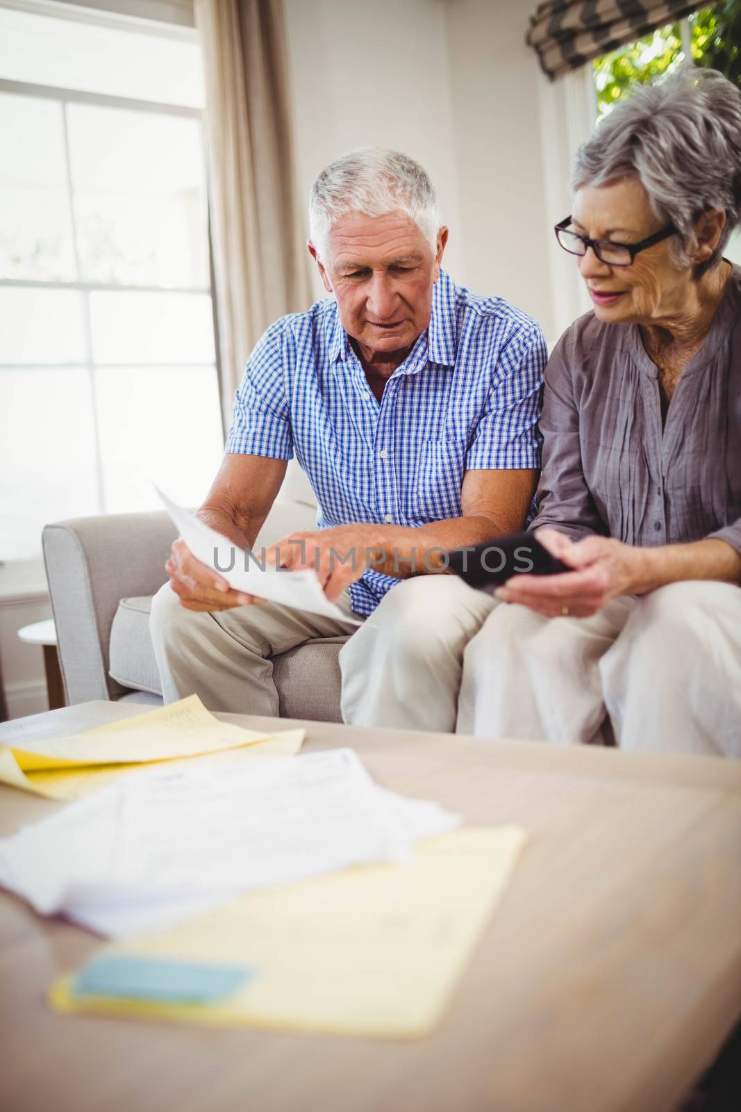 Senior man showing documents to woman by Wavebreakmedia