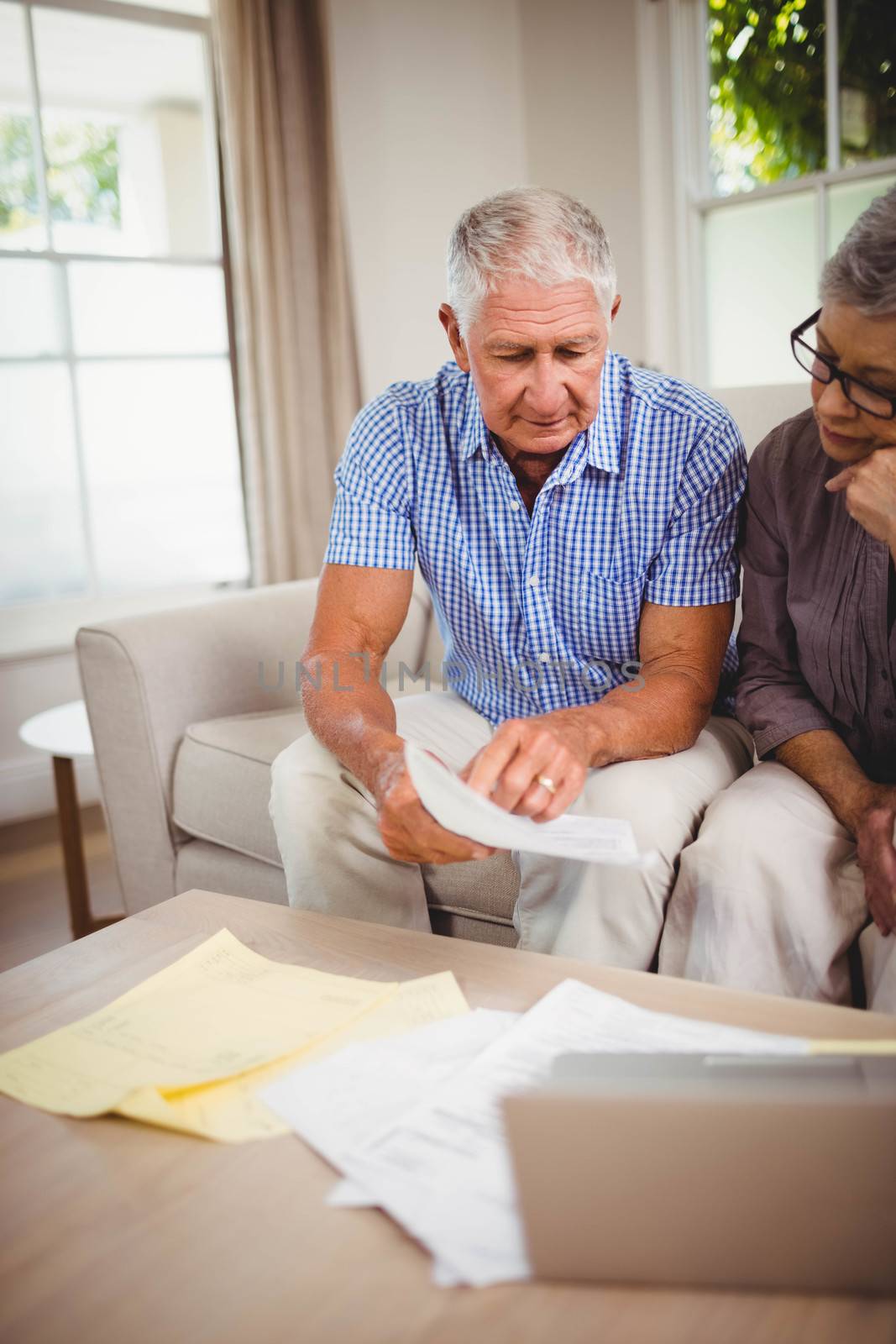 Senior man showing documents to woman by Wavebreakmedia