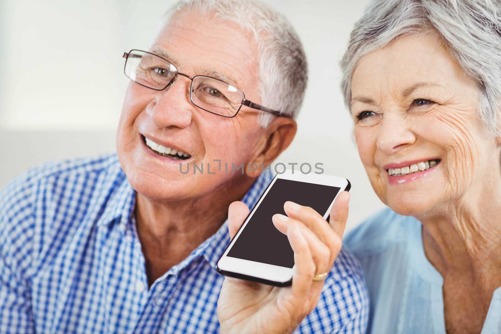 Senior couple talking on mobile phone by Wavebreakmedia