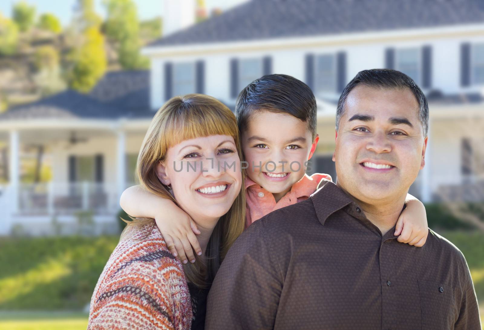 Happy Mixed Race Young Family in Front of House by Feverpitched