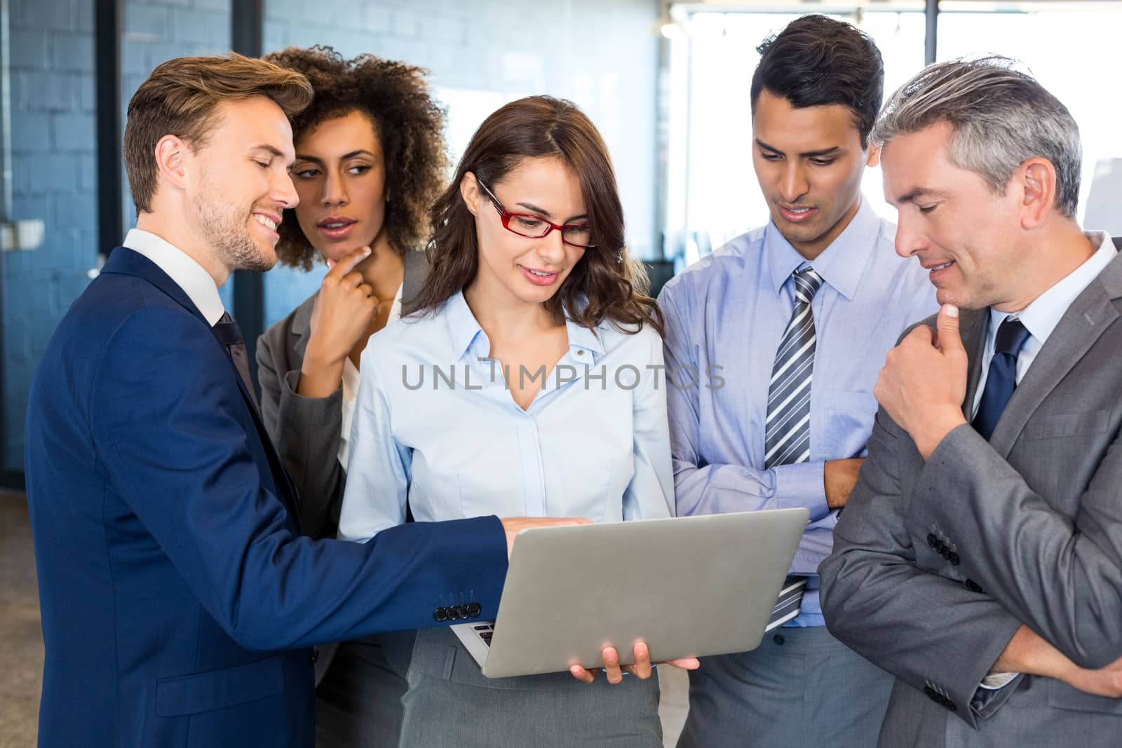 Business team standing together and interacting in office