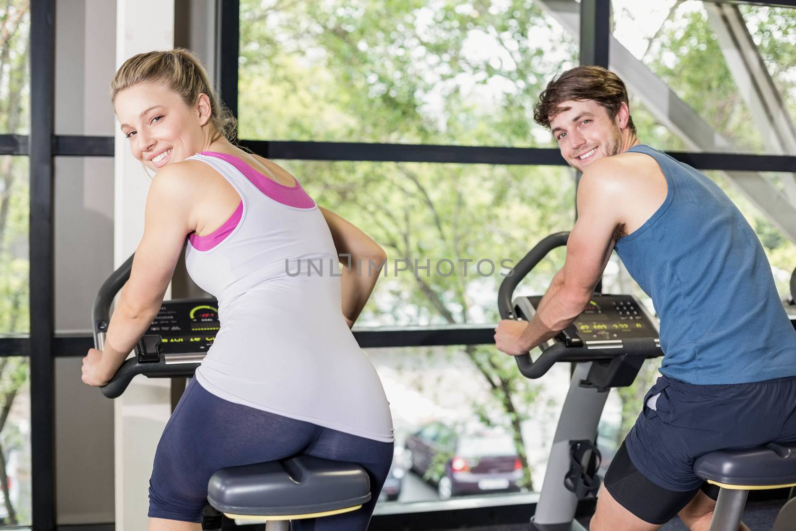 Fit people doing exercise bike by Wavebreakmedia