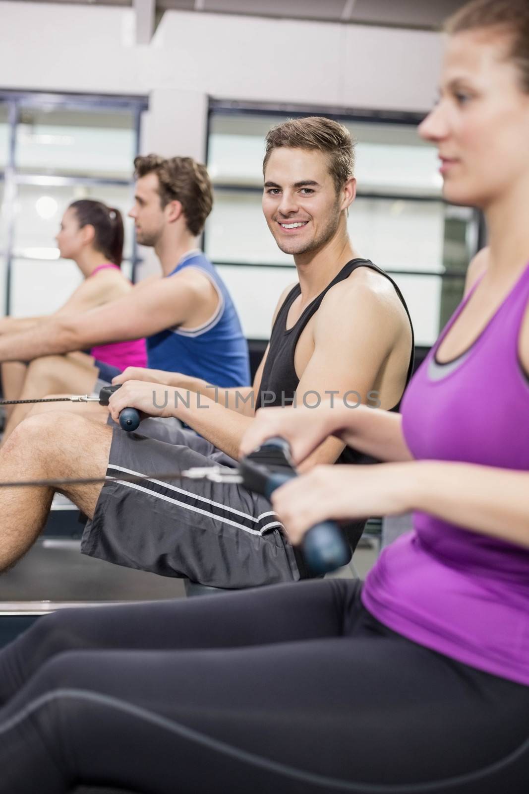 Fit people on drawing machine at gym