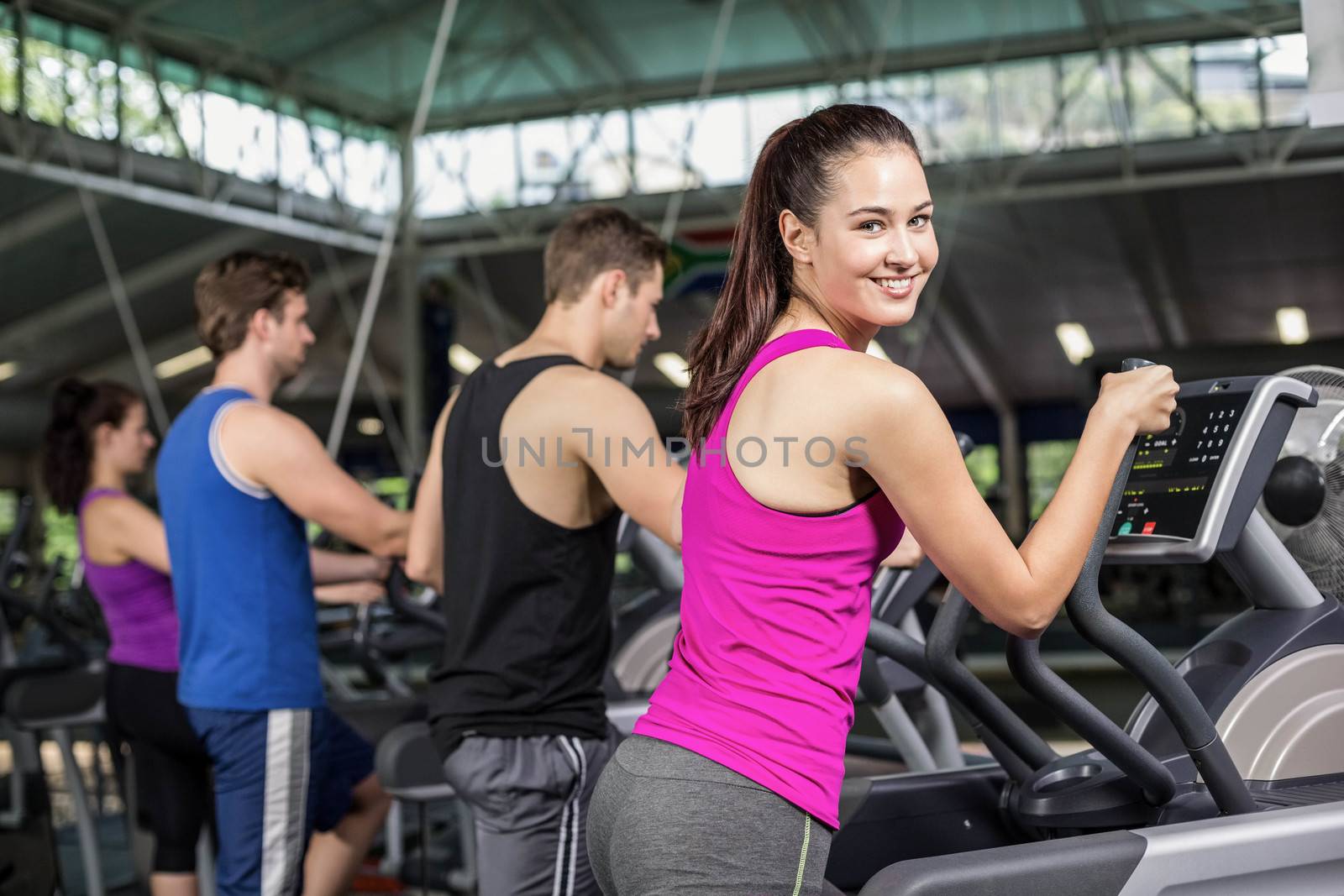 Fit people on elliptical bike by Wavebreakmedia