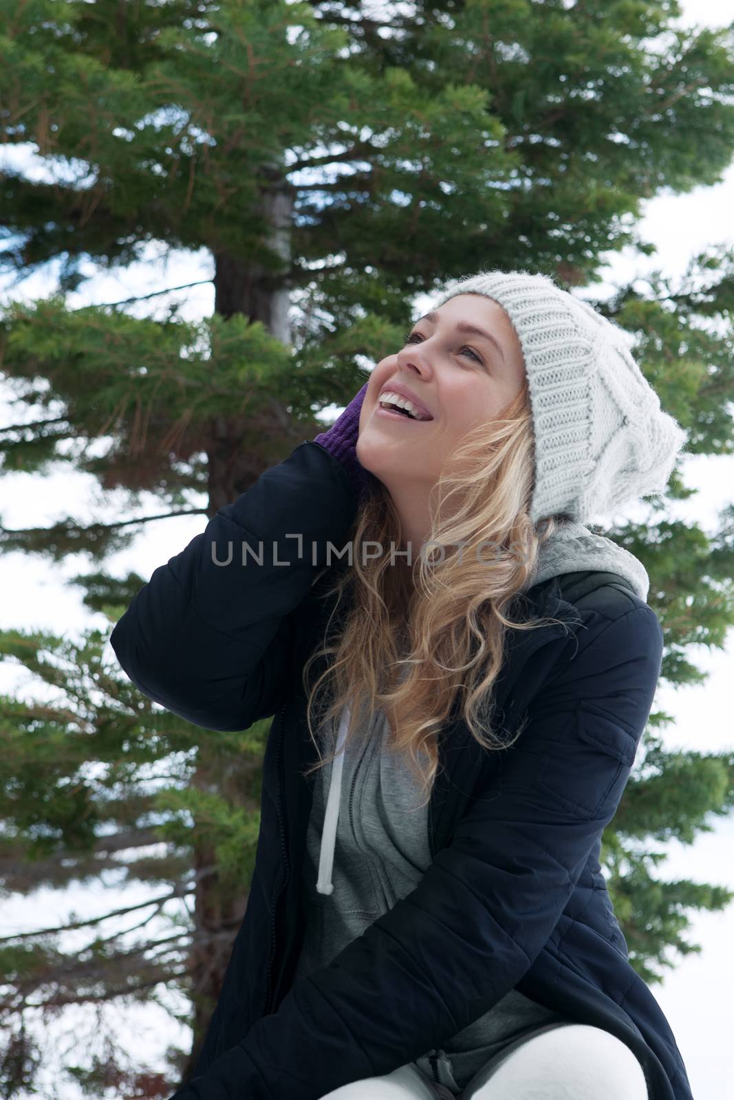 Portrait of young beautiful woman on winter outdoor background