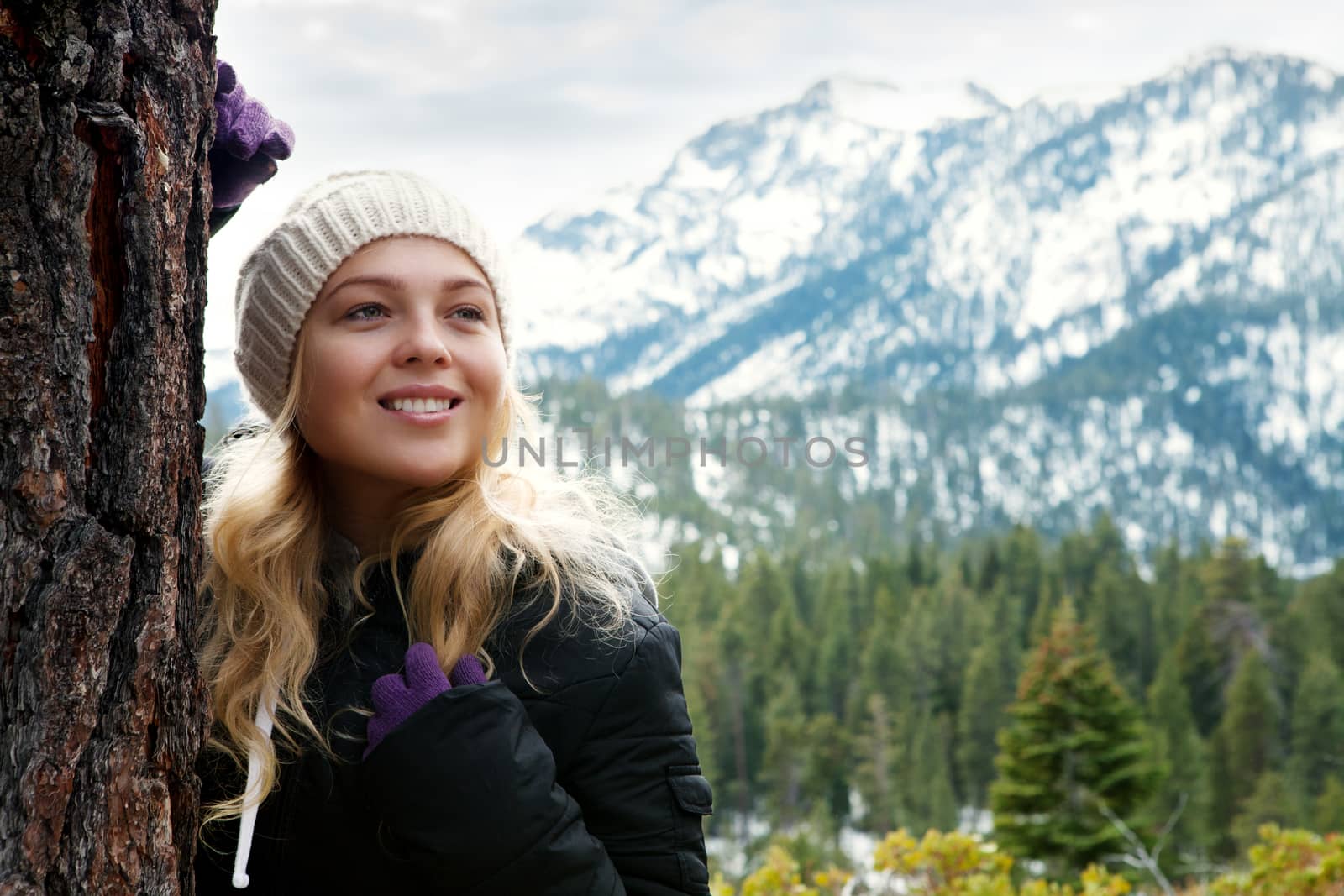 Portrait of young beautiful woman on winter outdoor background