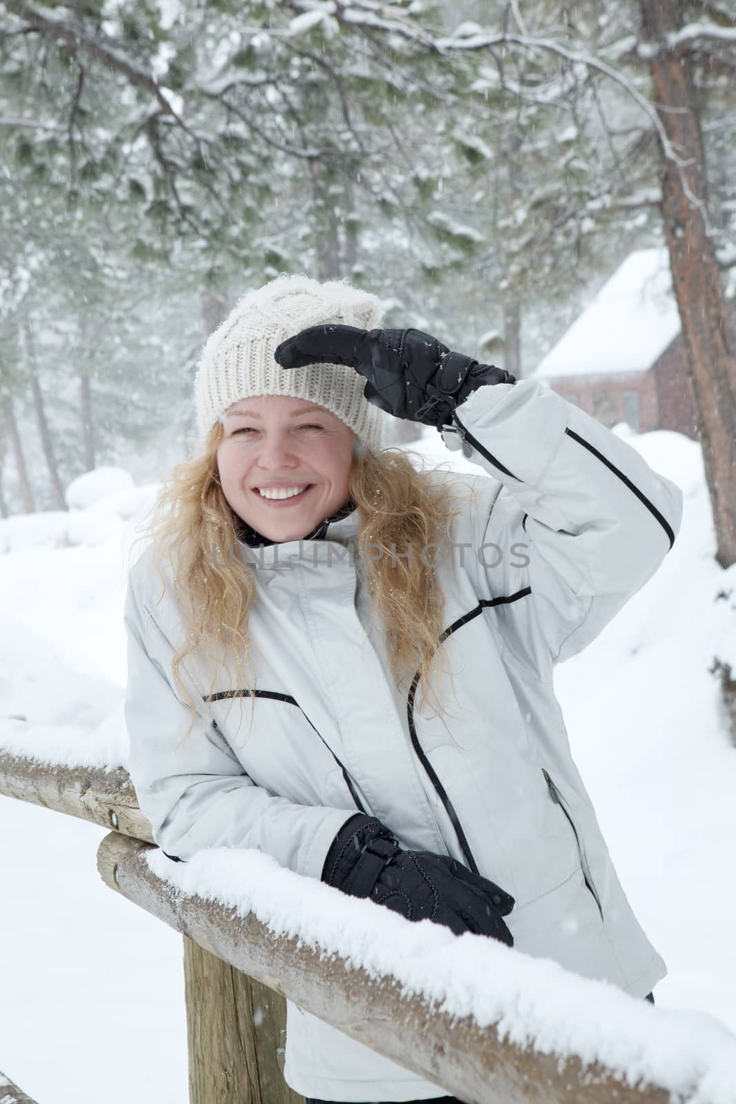 Portrait of young beautiful woman on winter outdoor background.