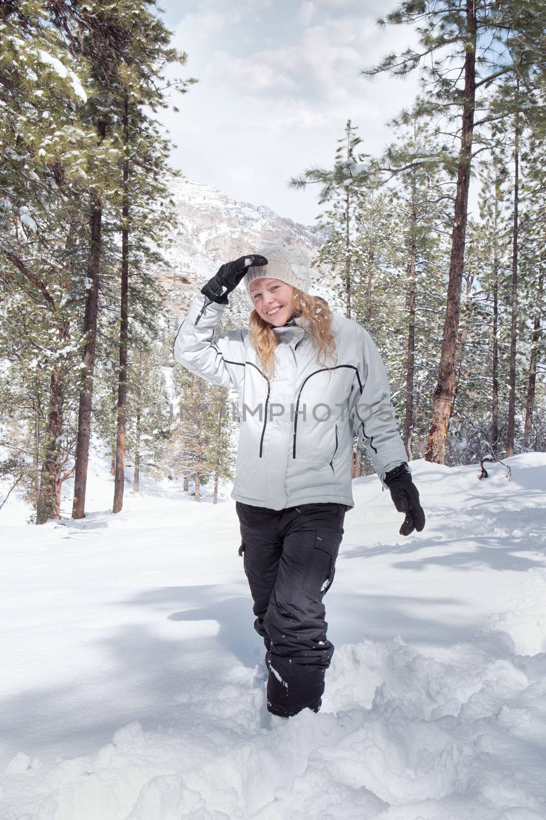 Portrait of young beautiful woman on winter outdoor background