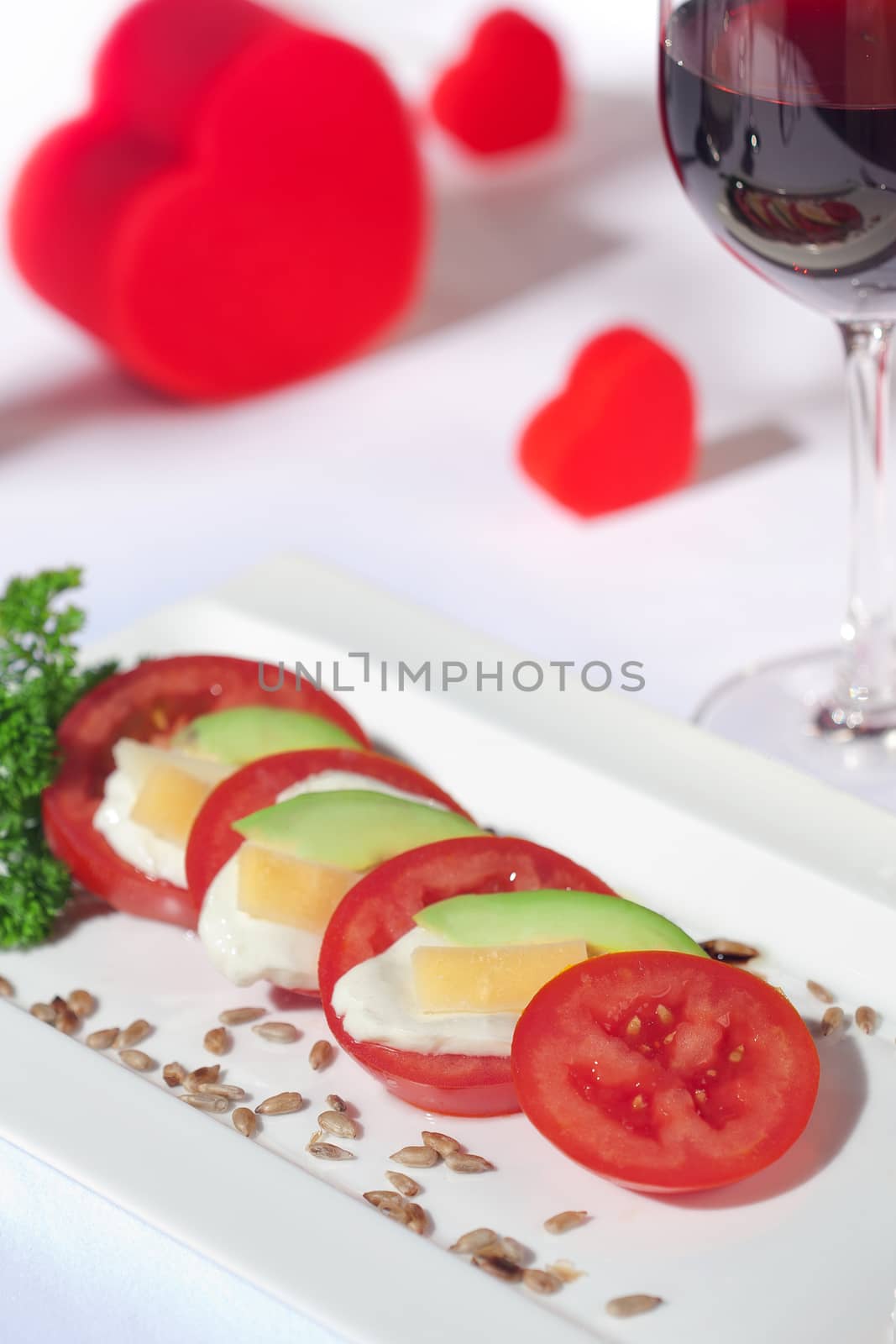 close up view of nice yummy caprese salad on white table clothe