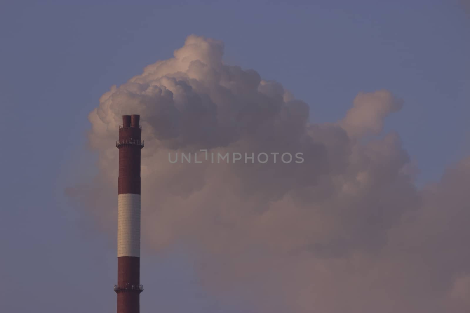 Tube with orange smoke on winter sunset