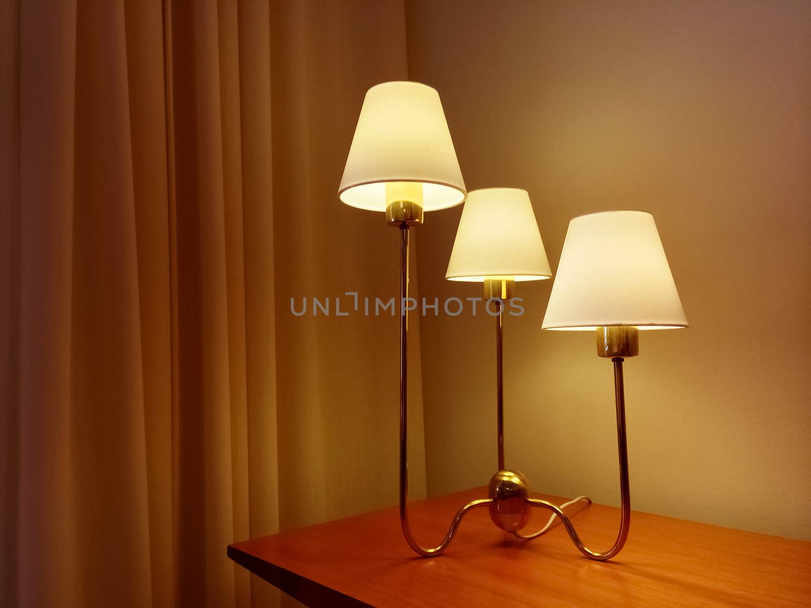 Classic style table lamp on wooden furniture, decorating a room.