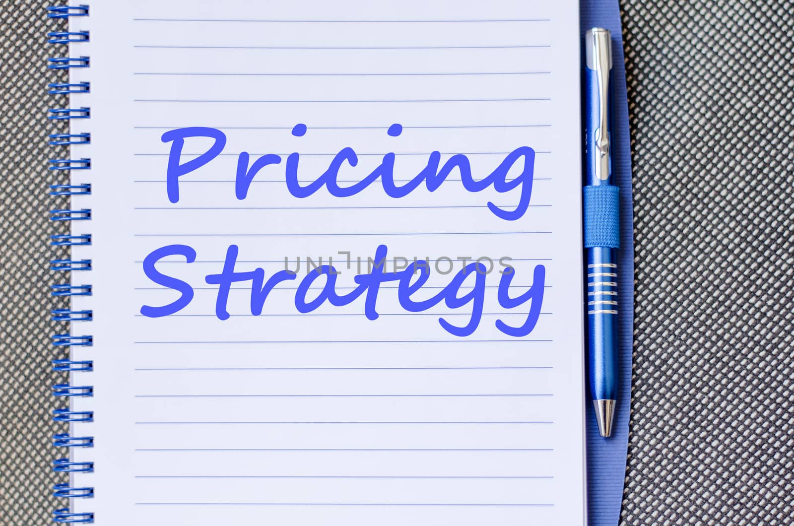 Pricing strategy text concept write on notebook with pen