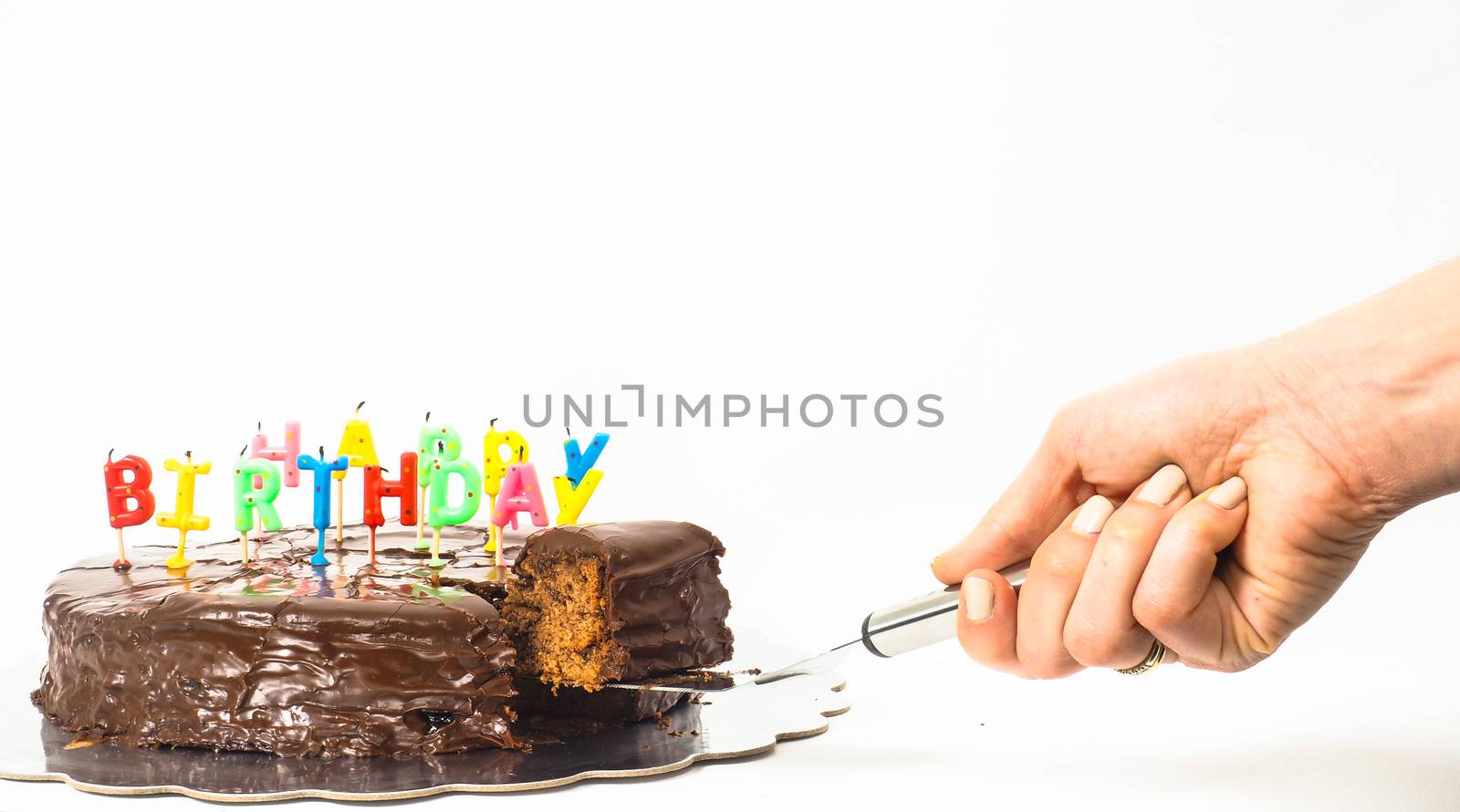 Female person serving a homemade sacher chocolate cake with birt by Arvebettum