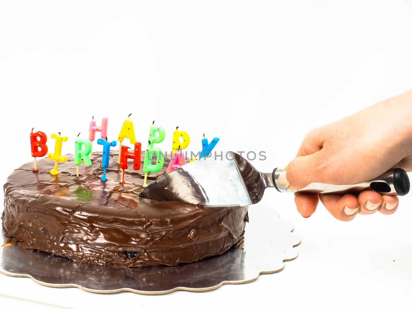 Female person cutting a homemade sacher chocolate cake with birt by Arvebettum