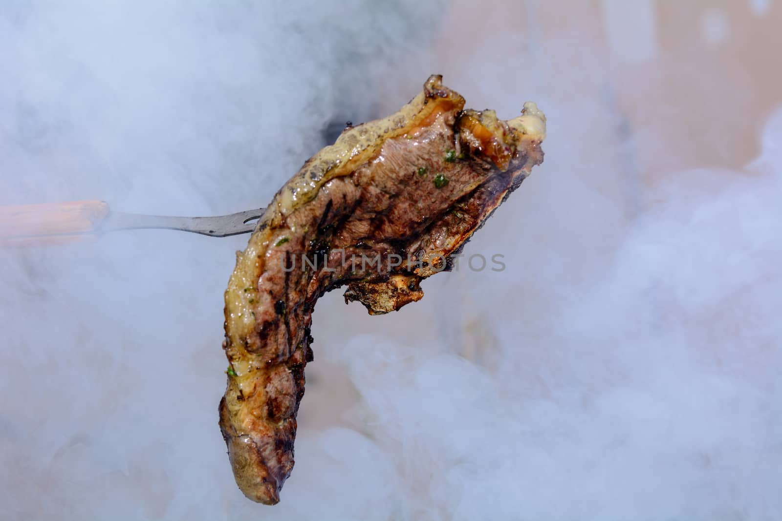 Roast beef, cooked in the outdoor barbecue in a rural location. Sauce: olive oil, salt, parsley.