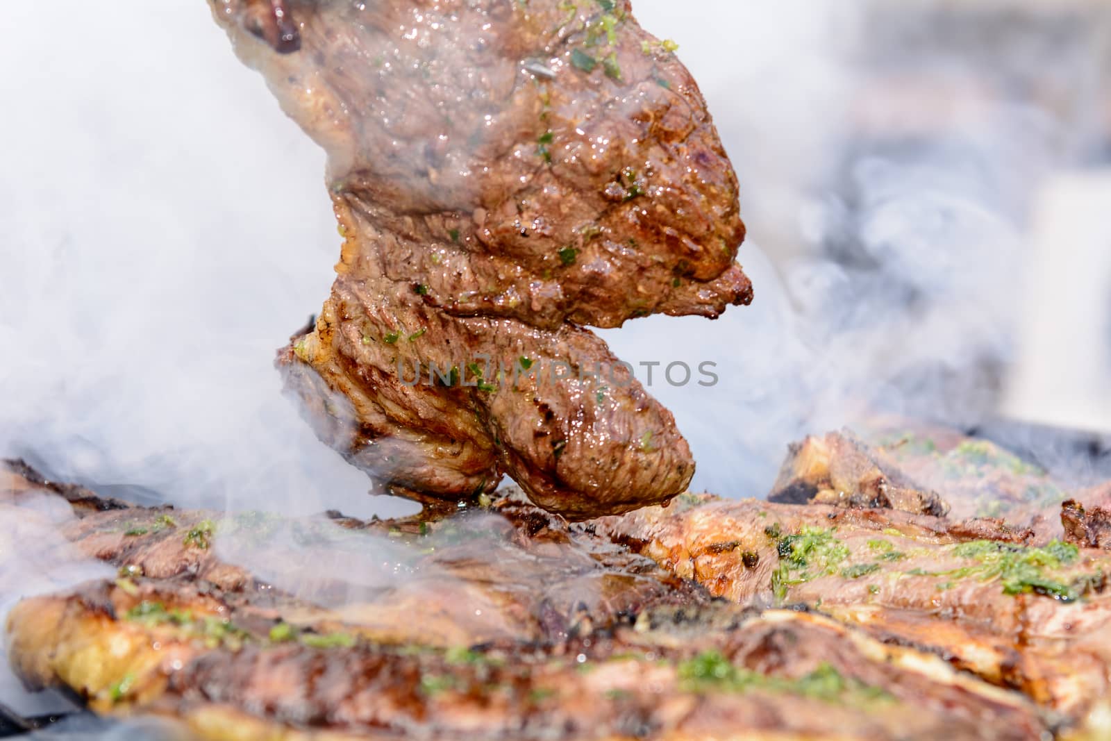 Roast beef, cooked in the outdoor barbecue in a rural location. Sauce: olive oil, salt, parsley.