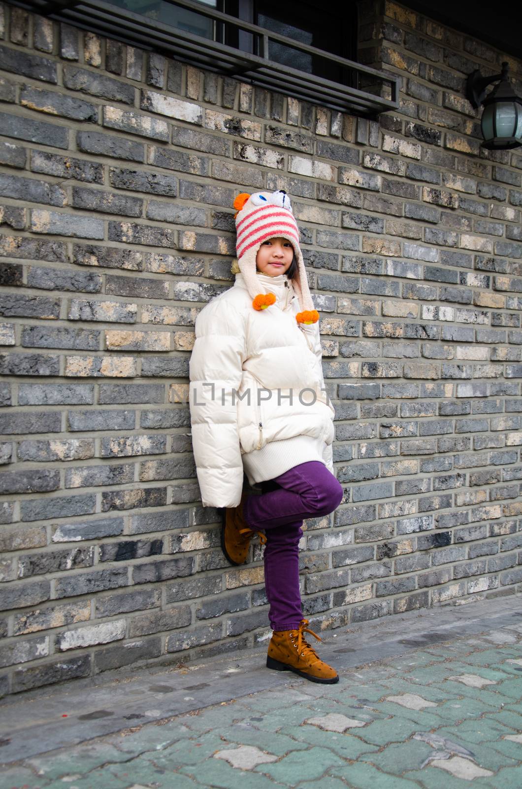 Portrait of cute fashionable children in overcoat on winter.