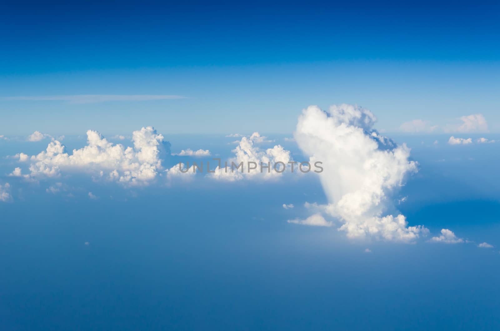 Blue sky and white clouds. view from the window of an airplane flying in the clouds.