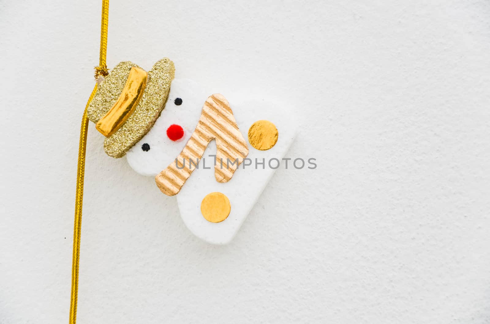 Little Snowman decoration on white wall.