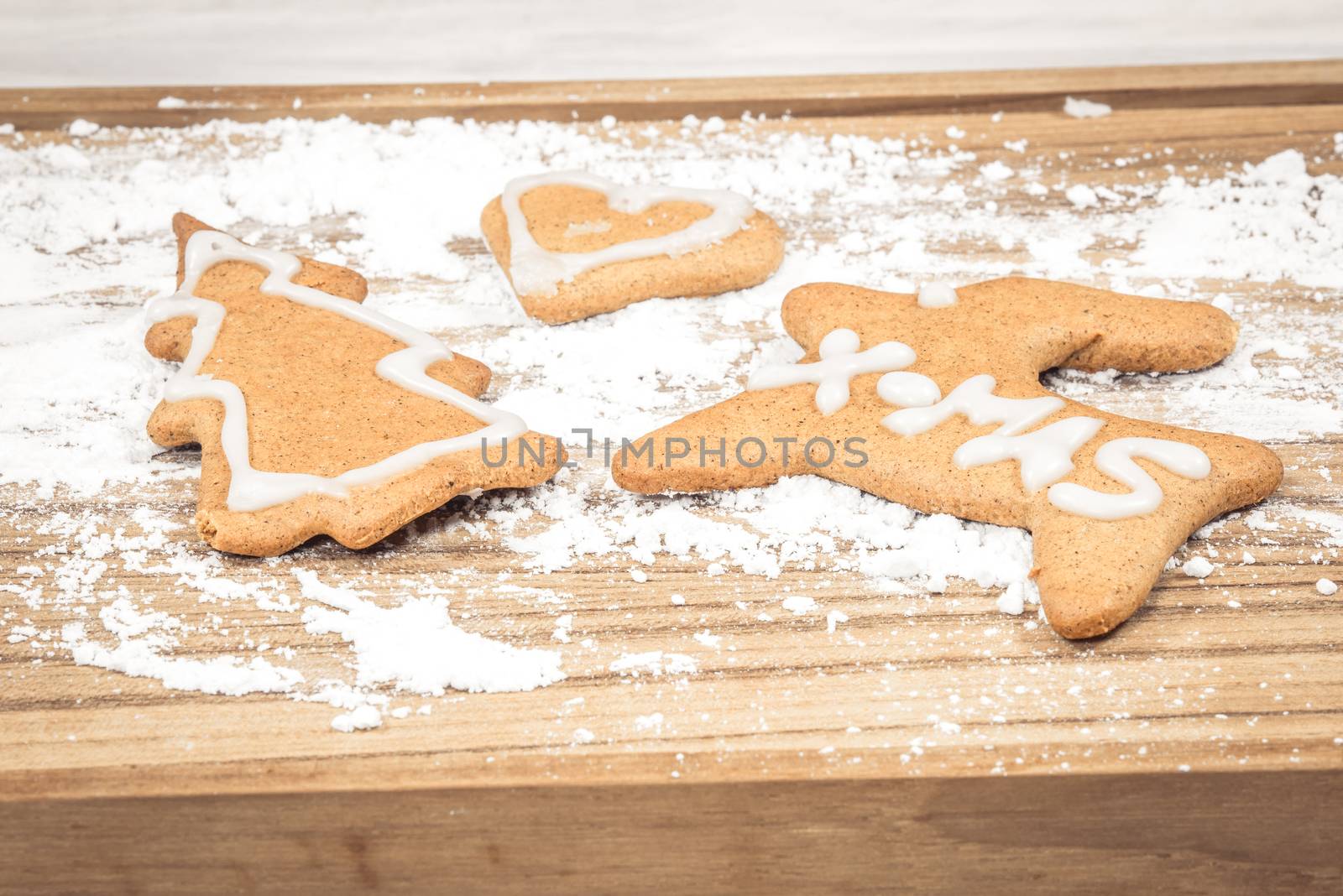 Xmas cookies in flour on a wooden board