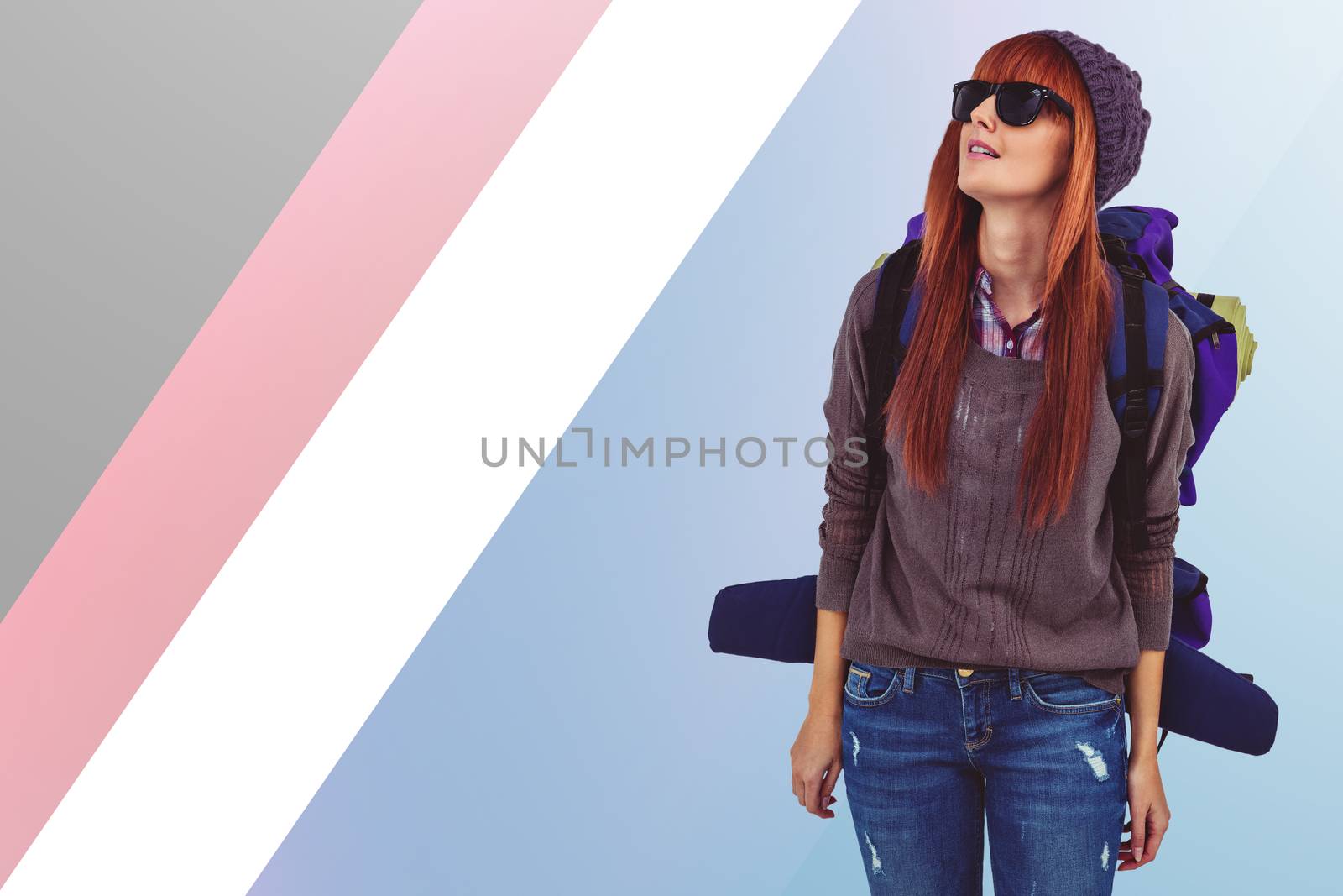 Portrait of a hipster woman with a travel bag against colored background