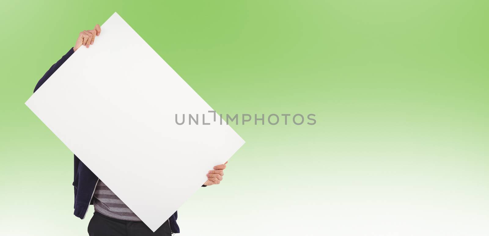 Man holding billboard in front of face against green background