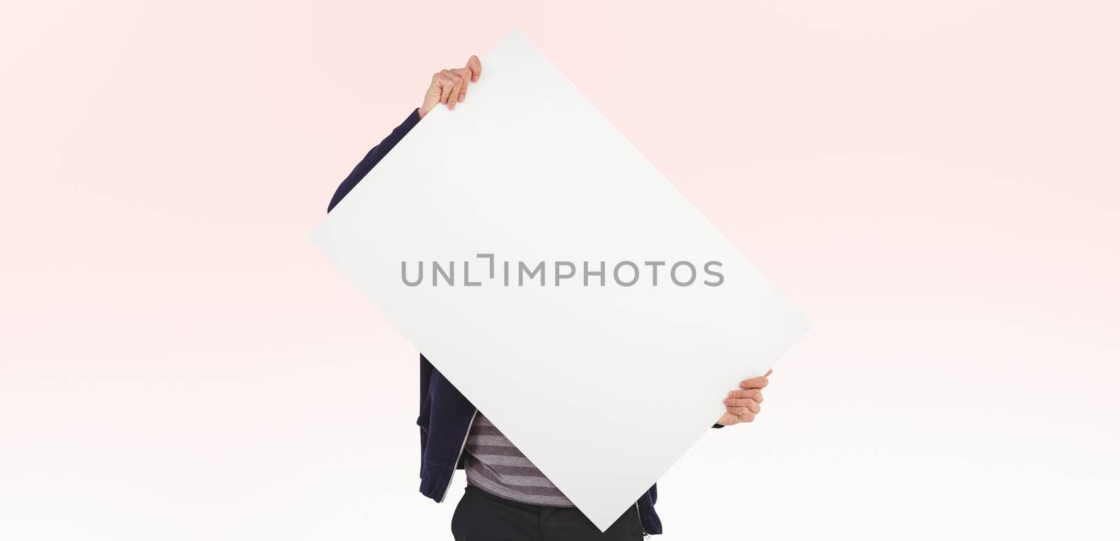 Composite image of man holding billboard in front of face by Wavebreakmedia
