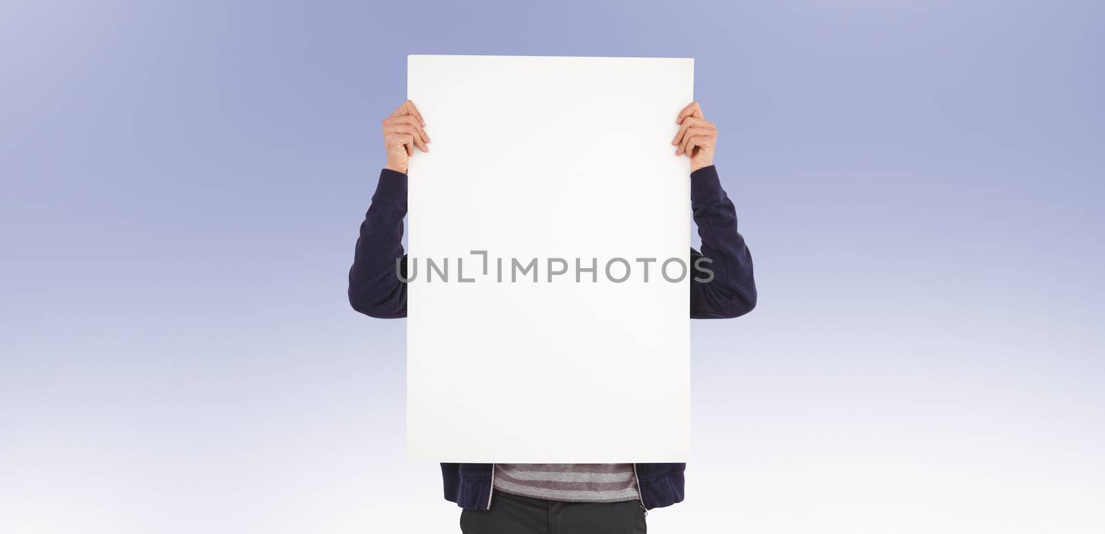 Man showing billboard in front of face against purple