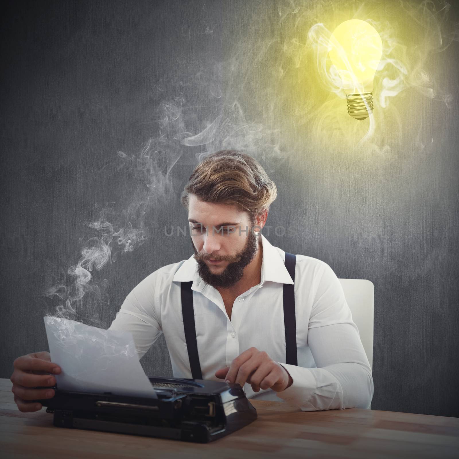 Hipster using typewriter at desk in office against white and grey background