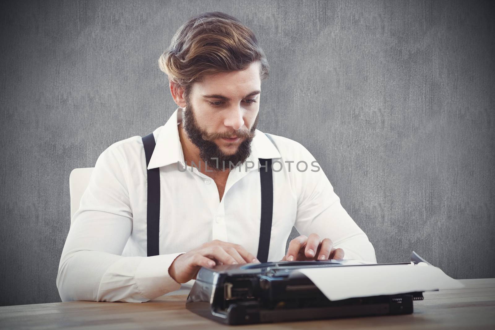 Hipster working on typewriter against white and grey background