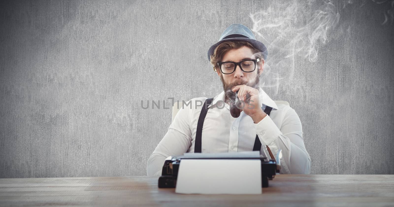 Hipster smoking pipe while sitting looking at typewriter against white and grey background