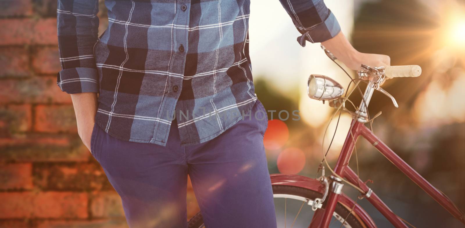 Composite image of mid section of hipster with bicycle by Wavebreakmedia