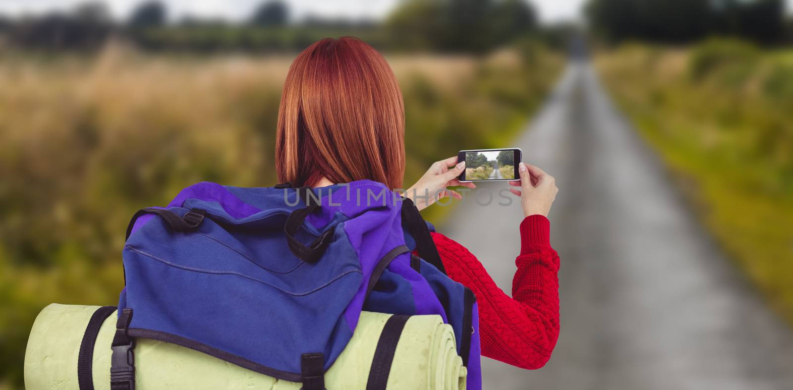 Smiling hipster woman with a travel bag against picture of an empty street