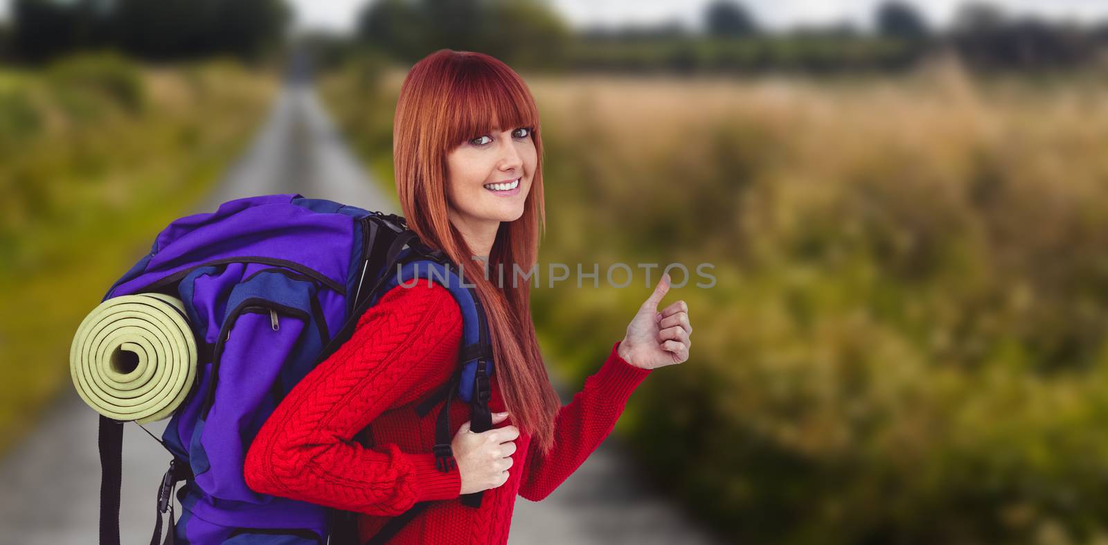 Smiling hipster woman with a travel bag against picture of an empty street