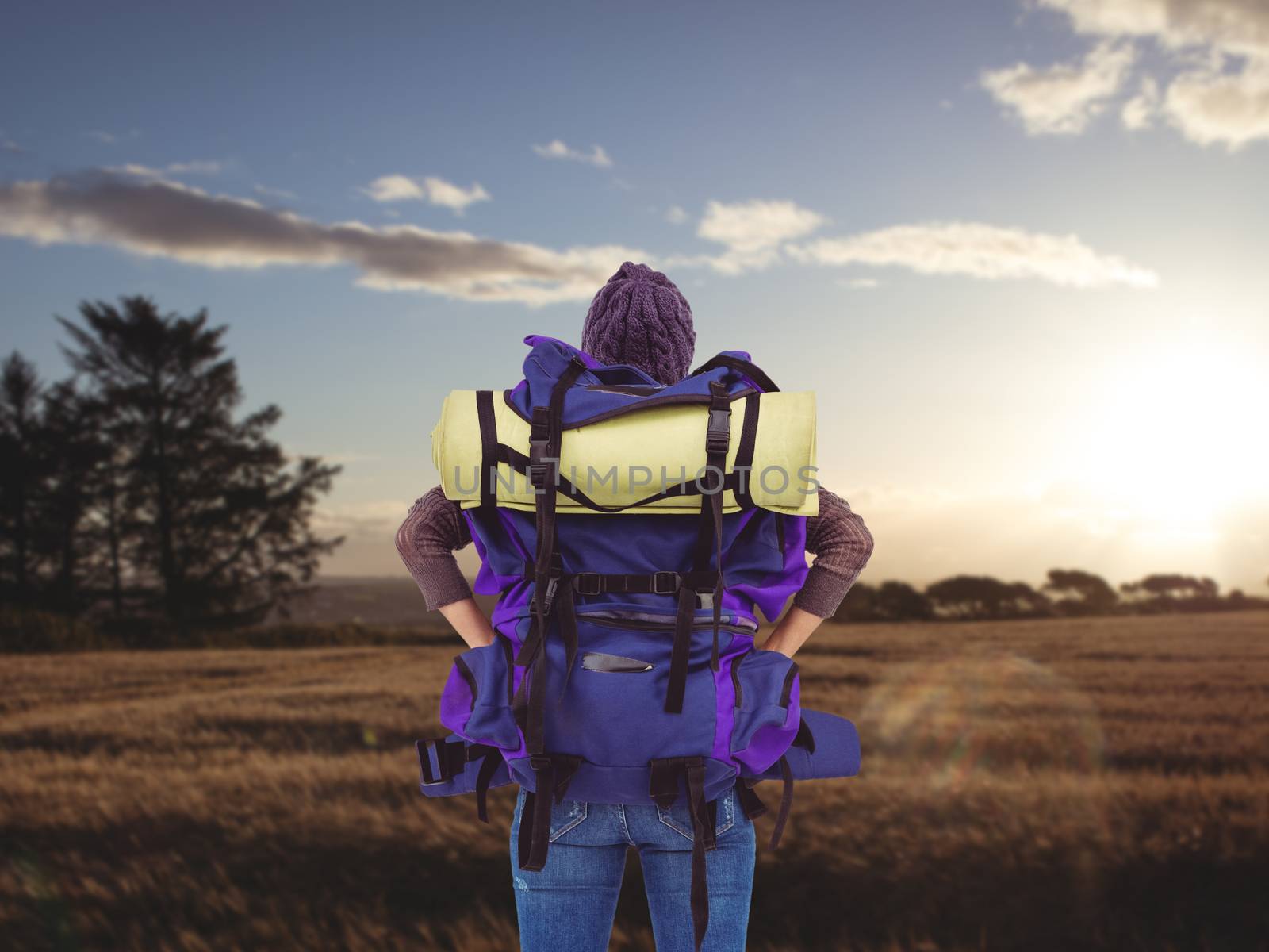 Composite image of rear view of a hipster woman with a travel bag by Wavebreakmedia