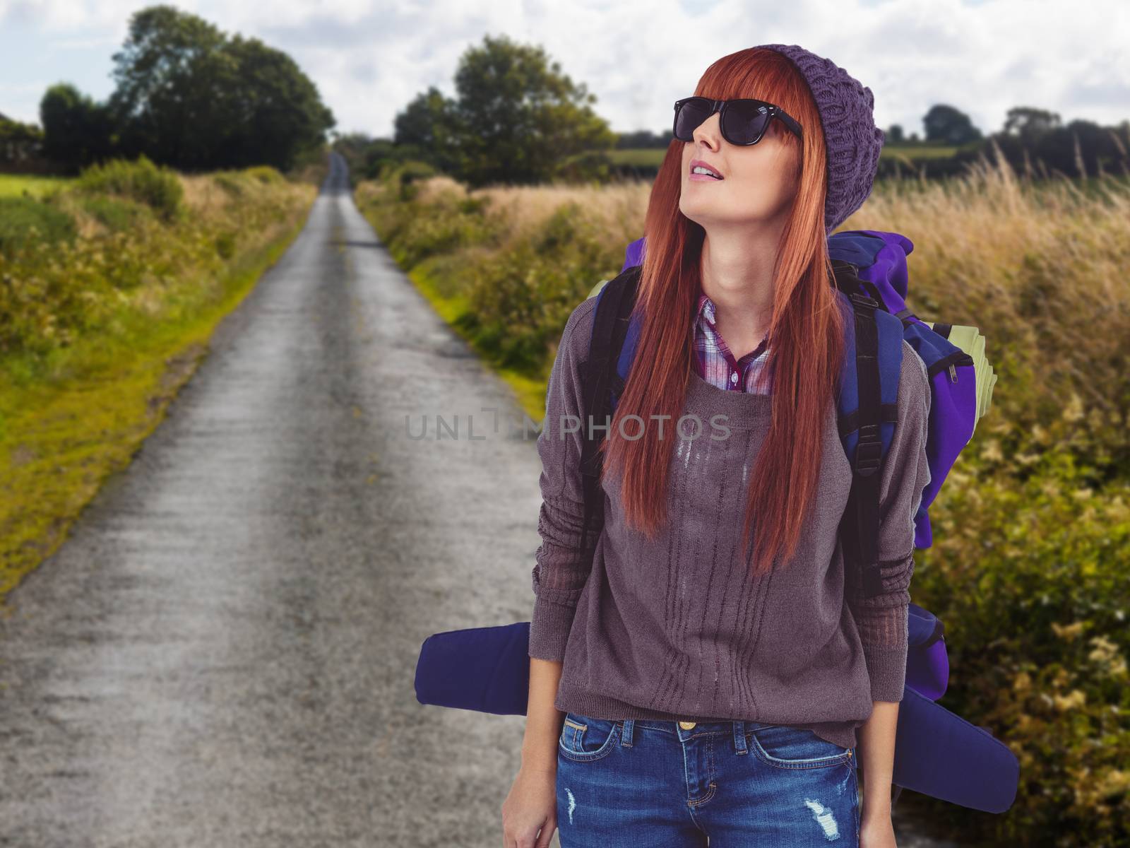 Portrait of a hipster woman with a travel bag against picture of an empty street