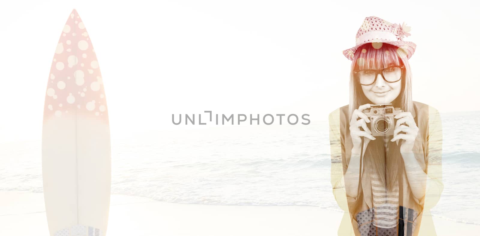 Portrait of a smiling hipster woman holding retro camera against surf board standing on the sand