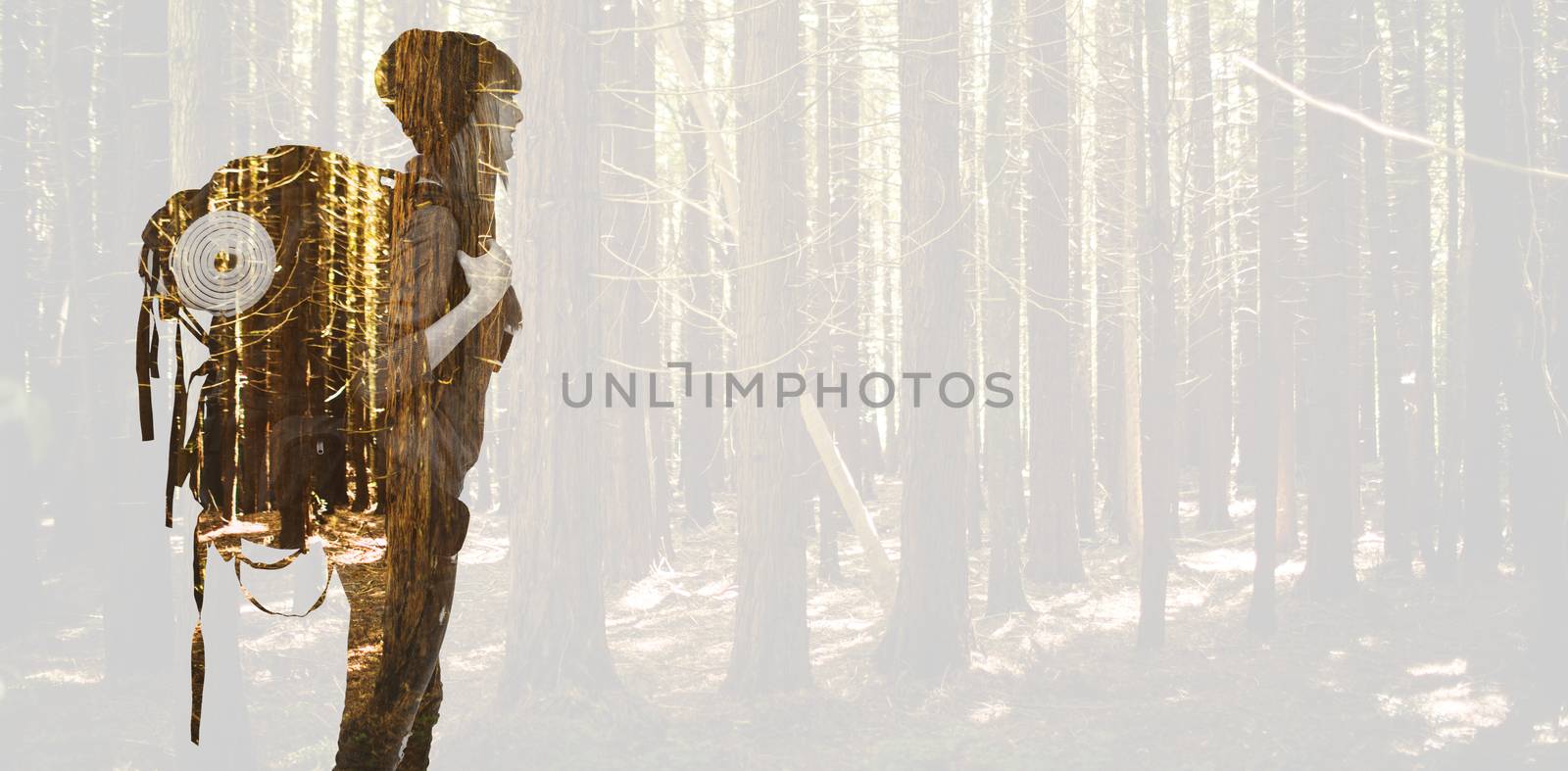 Side view of a hipster woman with a travel bag against trees in a woods