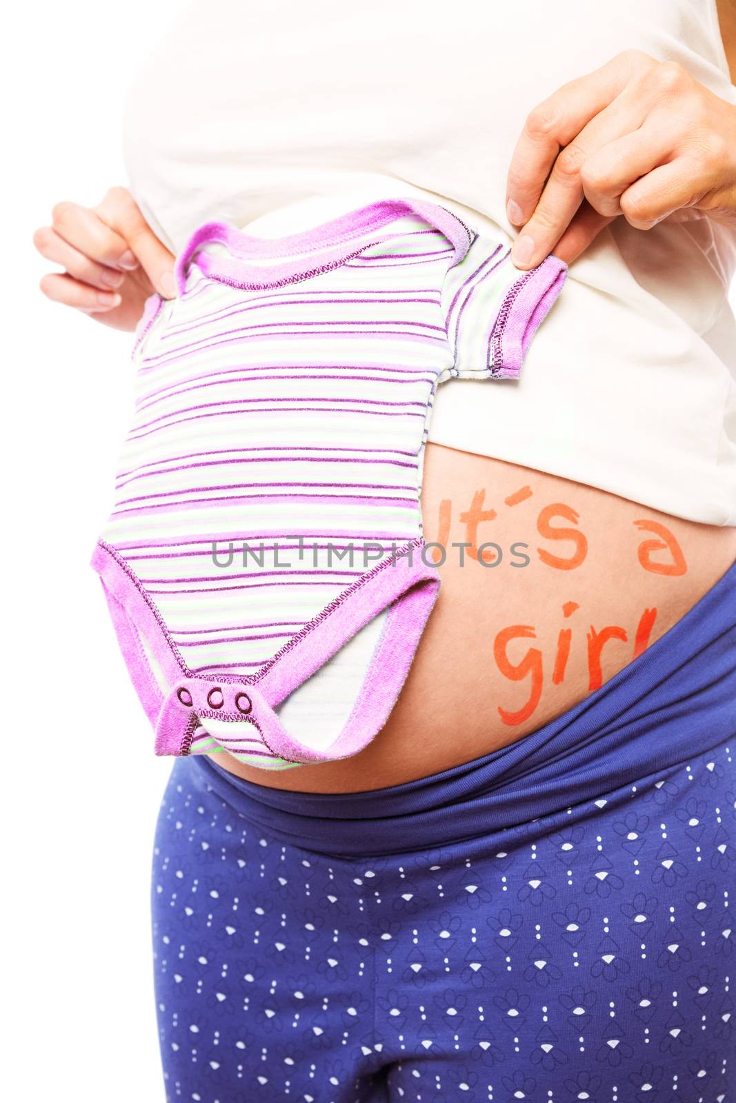 Pregnant woman holding pyjamas over her belly by Wavebreakmedia