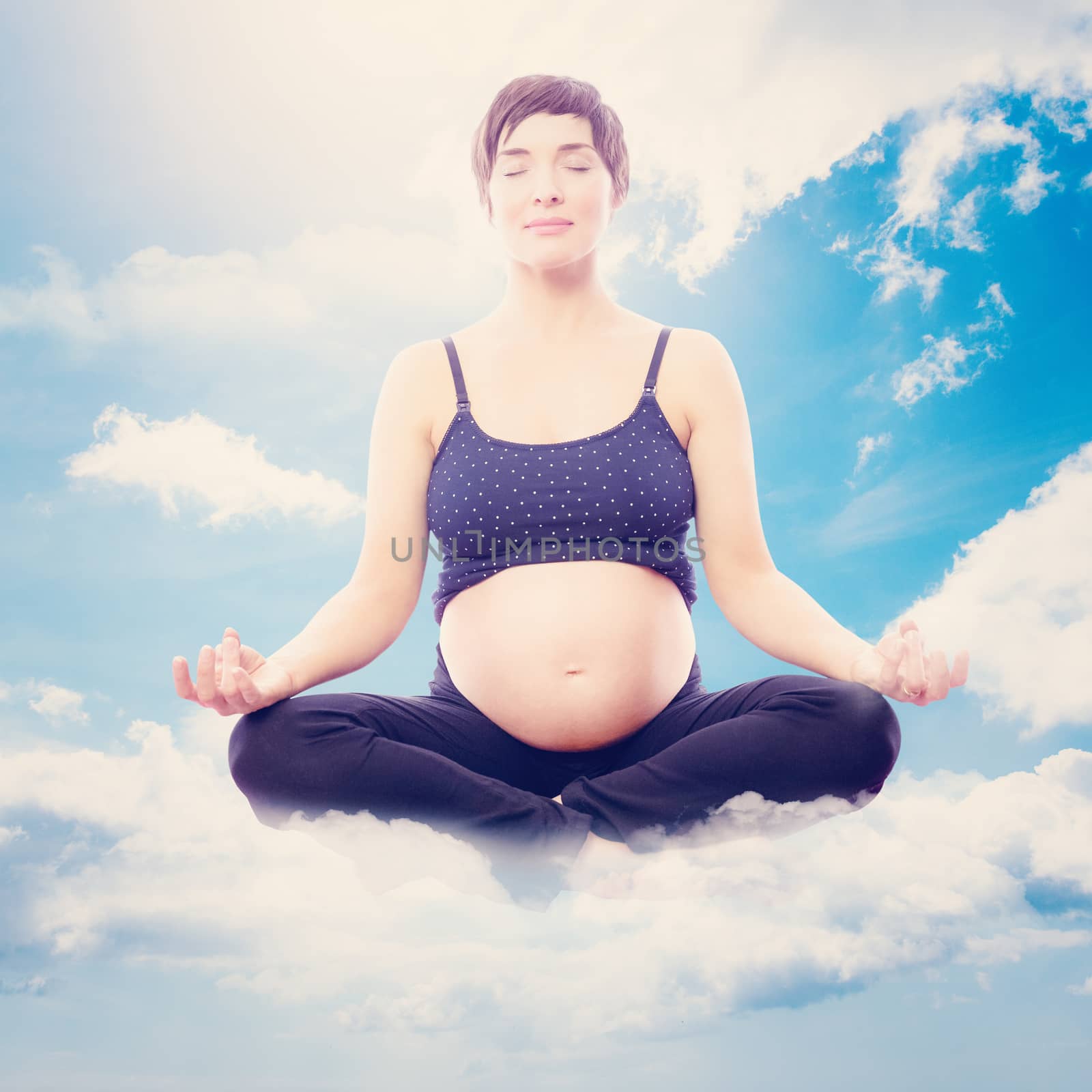 Composite image of pregnent woman sitting on mat in lotus pose over white background by Wavebreakmedia