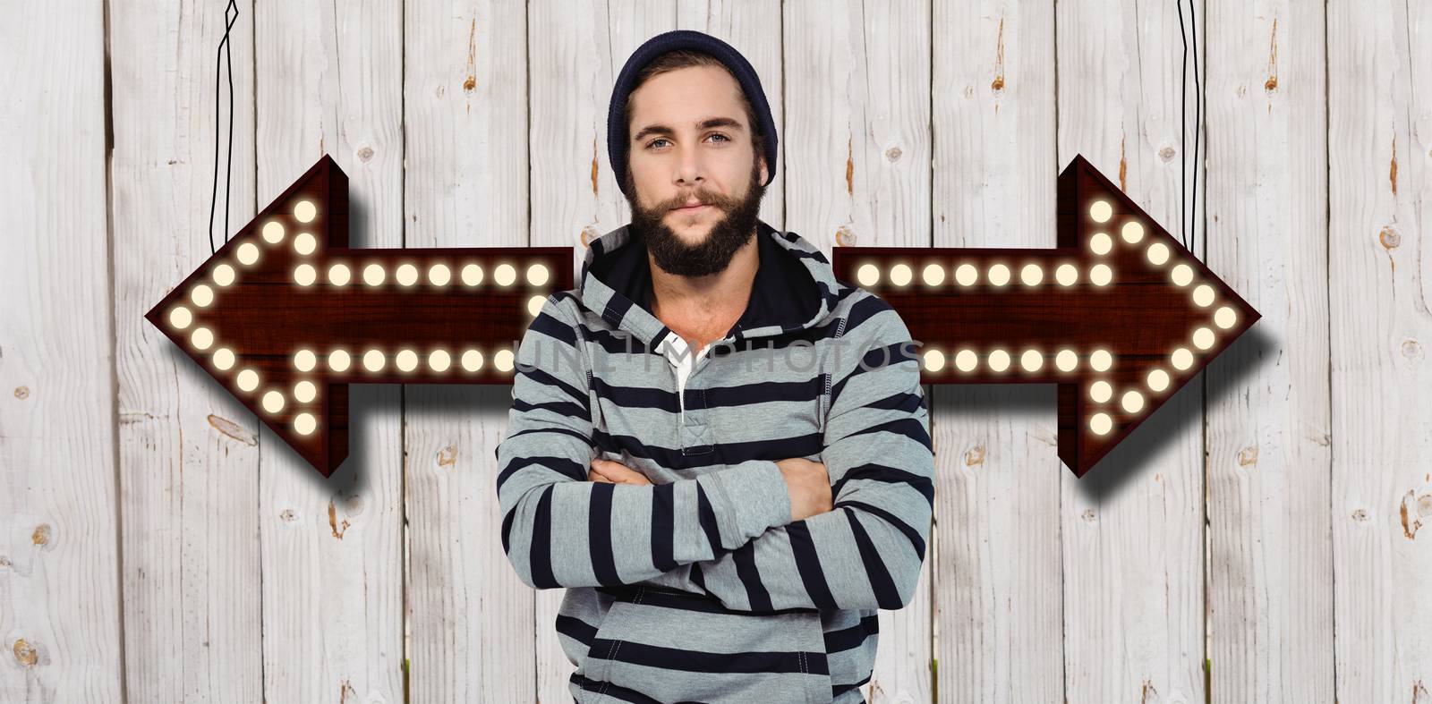 Portrait of hipster with hooded shirt against wooden background