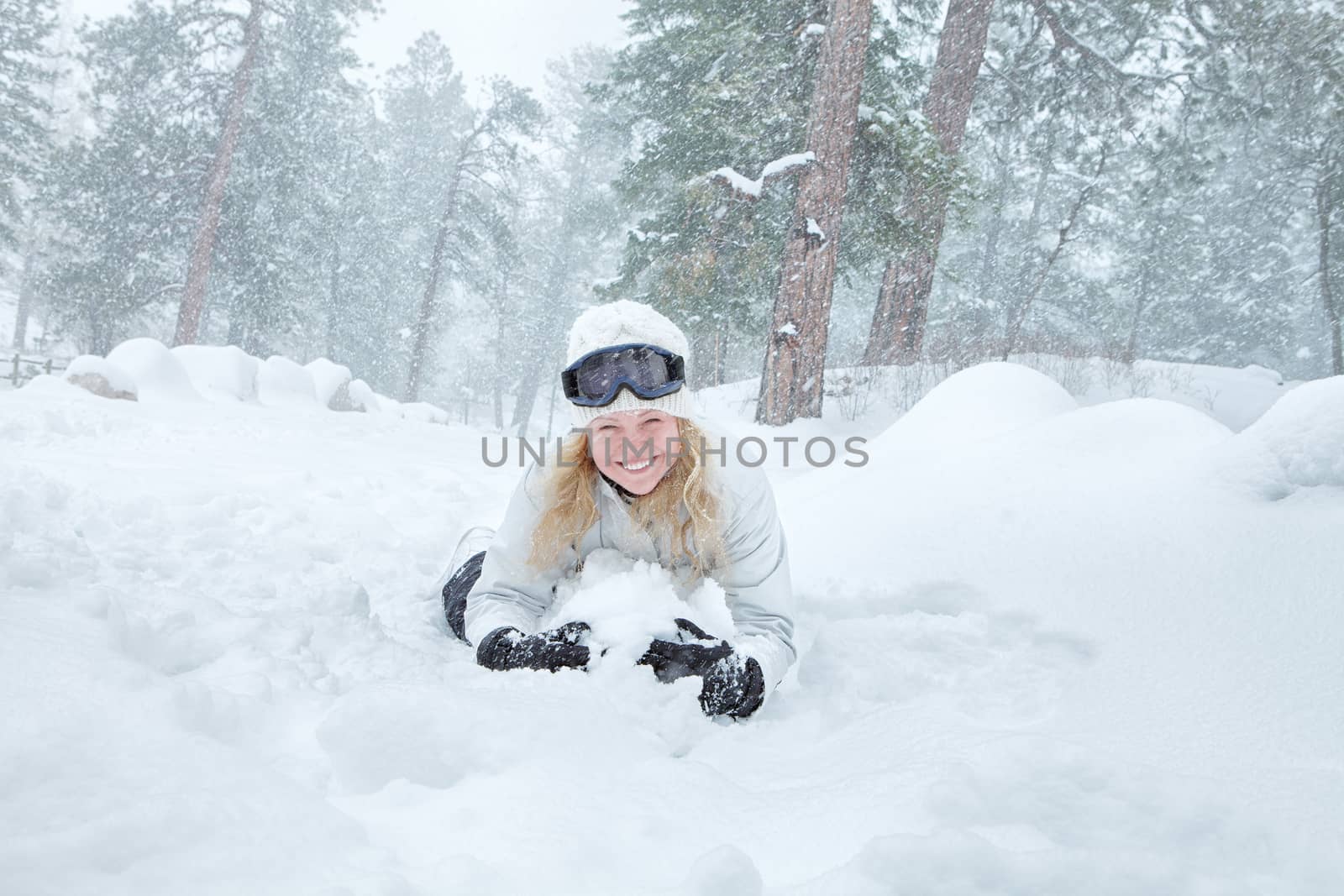 Portrait of young beautiful woman on winter outdoor background