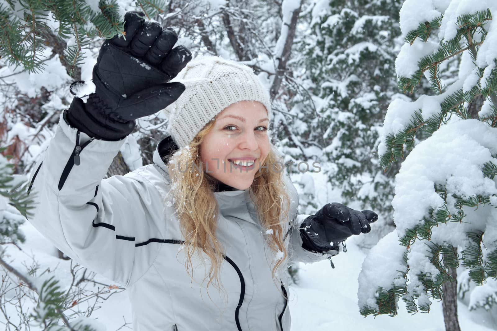 Portrait of young beautiful woman on winter outdoor background